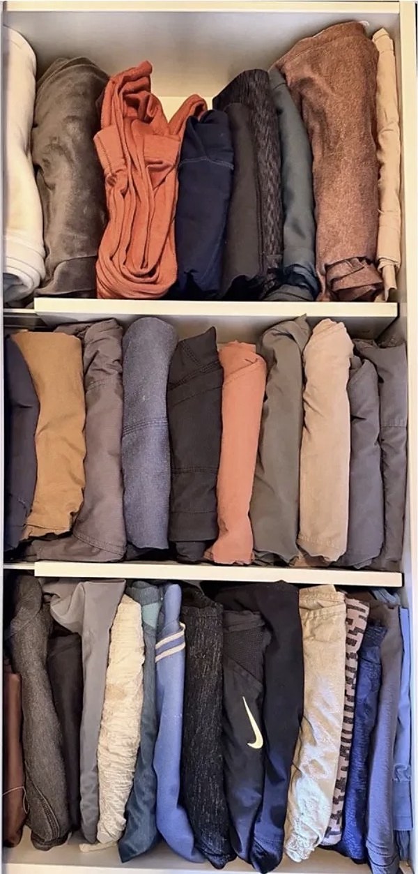 Drawer with clothes folded and filed by category after organizing
