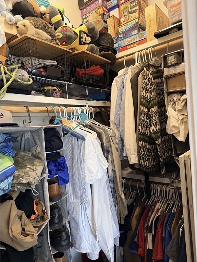 Closet crowded with clothes and boxes before organizing