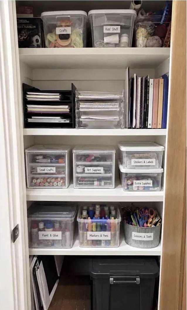 Craft closet with labeled bins and sorted supplies after organizing